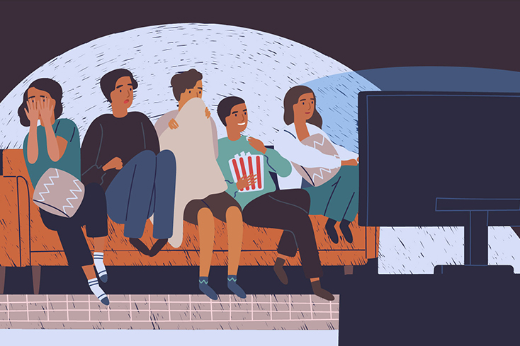people on couch watching scary movie