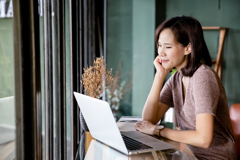 Woman reading laptop