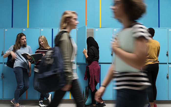 teens walking in school hallway